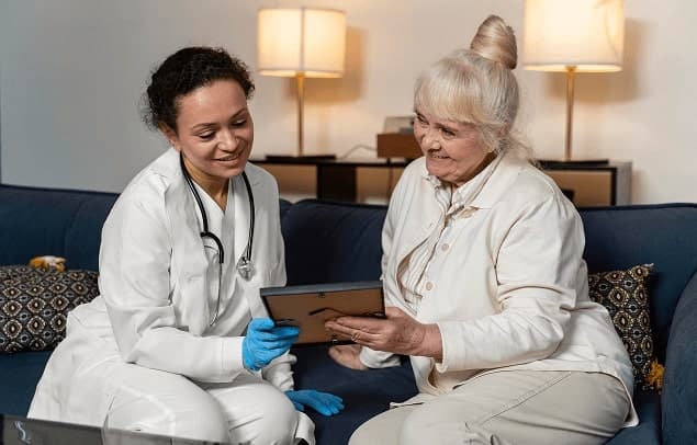 A care professional reviewing information with an older woman